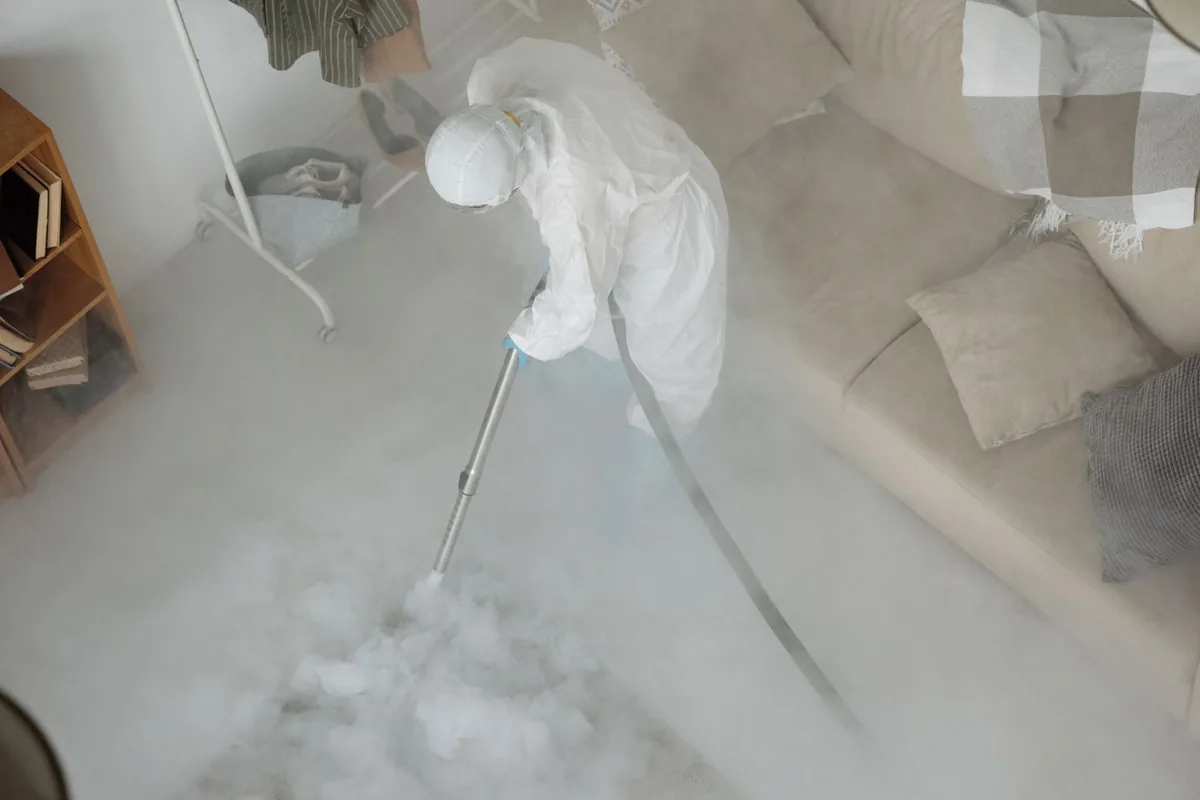 Biohazard cleanup technician in protective equipment, Penrose, CO